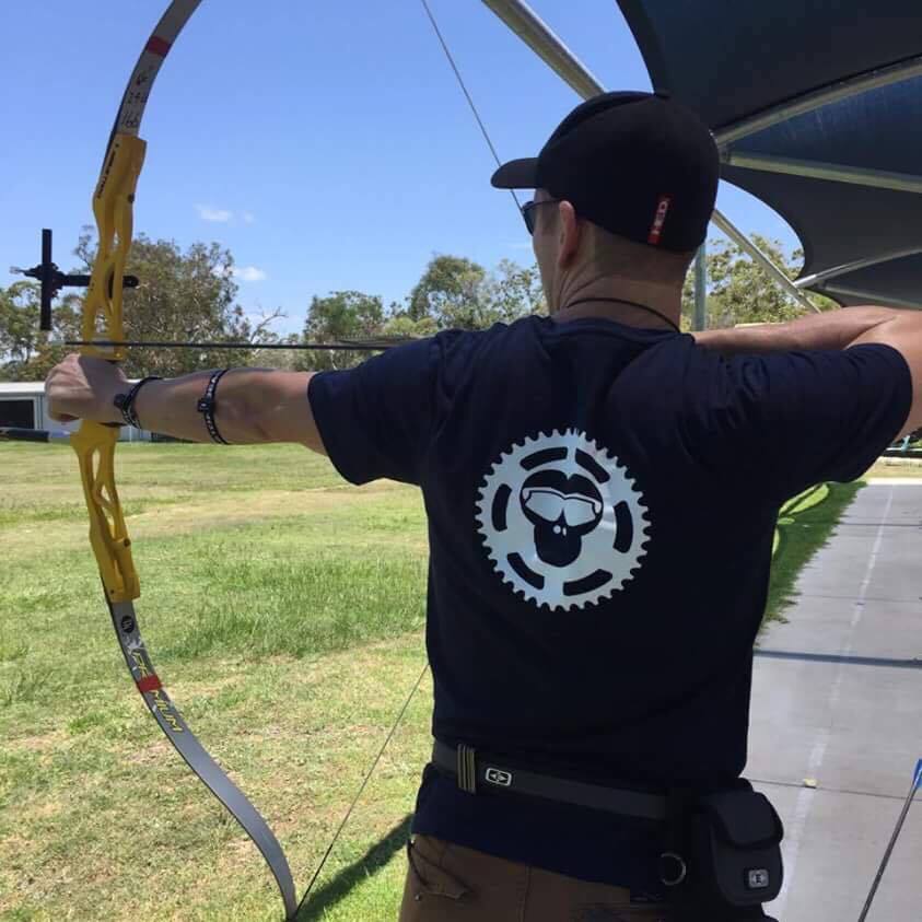Jason practicing his archery with Tri Monkey T Shirt