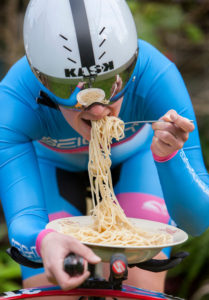 Cyclist eating bowl of spaghetti